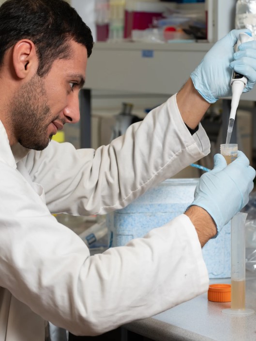 A scinetist using a pipette